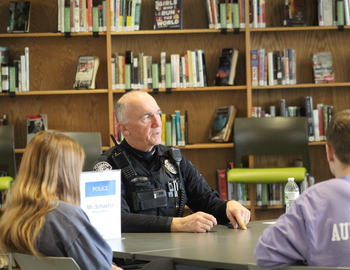 Students talking to a local police officer