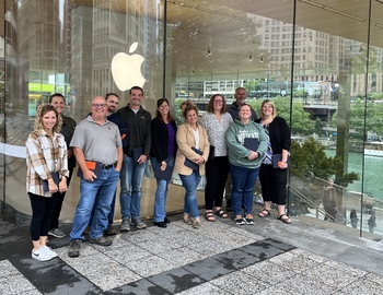 Staff in front of Apple logo in Chicago