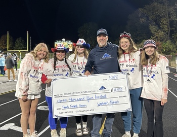 Student council members presenting large check