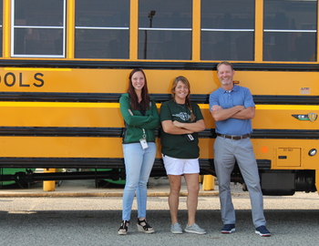 Tim Reeves, Leslie Wagner and Karla Heckathorn standing next to new bus