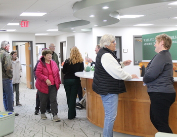 Staff and community members standing in new Administration Building Lobby