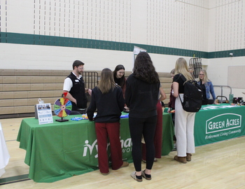 Students talk to representatives at a booth