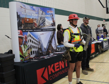 Student trying on gear at a booth