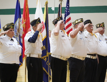 Veterans saluting American Flag