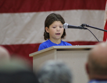 Student reading during assembly