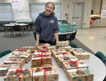 Kynlee with her boxed up cookies.