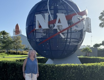 Mrs. Foster in front of the NASA globe