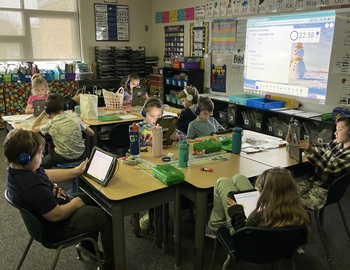 Group of elementary students on iPads