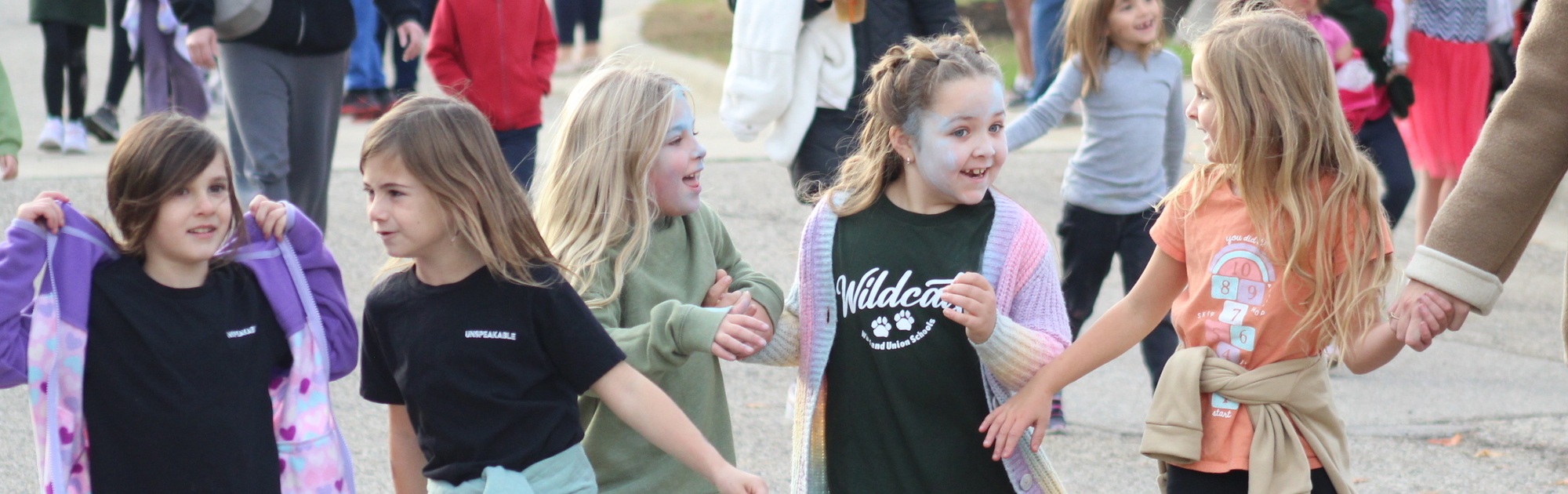 Five Baker Elementary students walking together during the Walk-a-thon