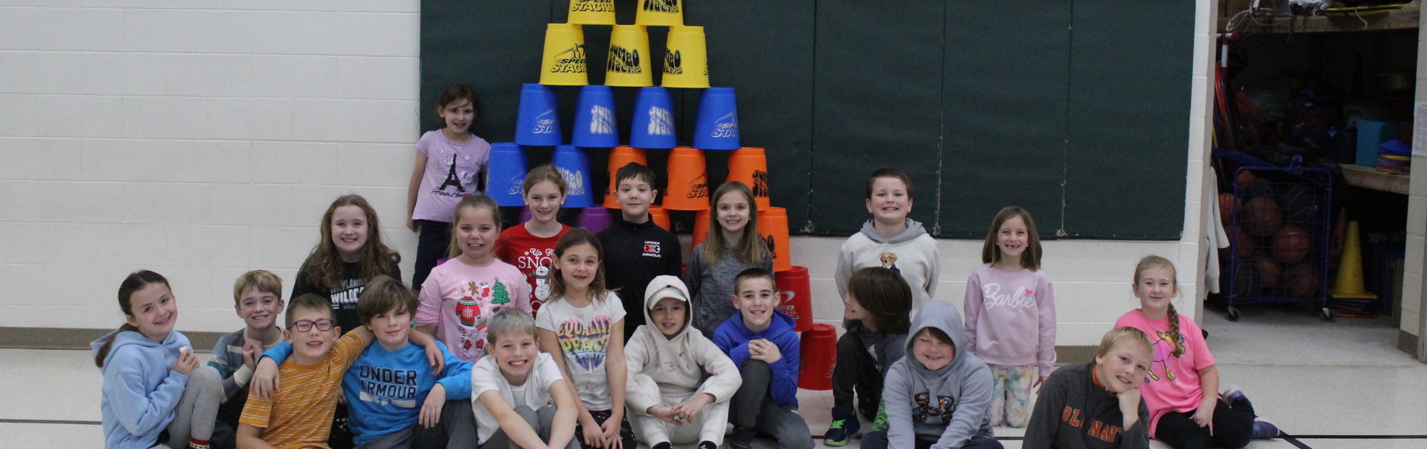 3rd grade students in front of giant cup stack