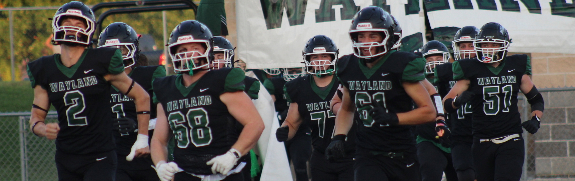 Football team running out for homecoming game