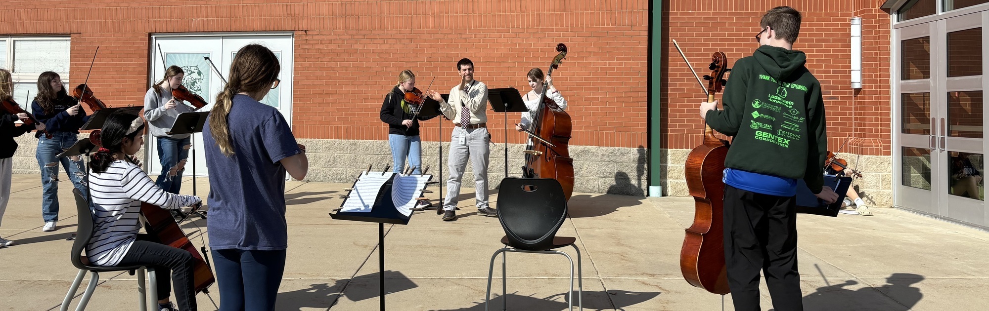 8th Grade Orchestra Playing Outside
