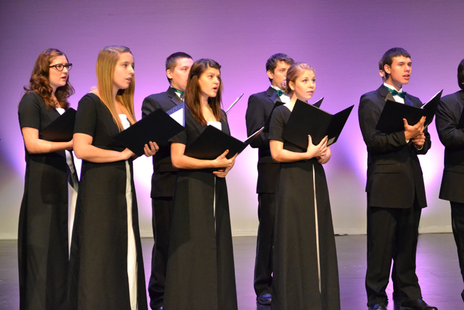 photo of choir students performing on stage.