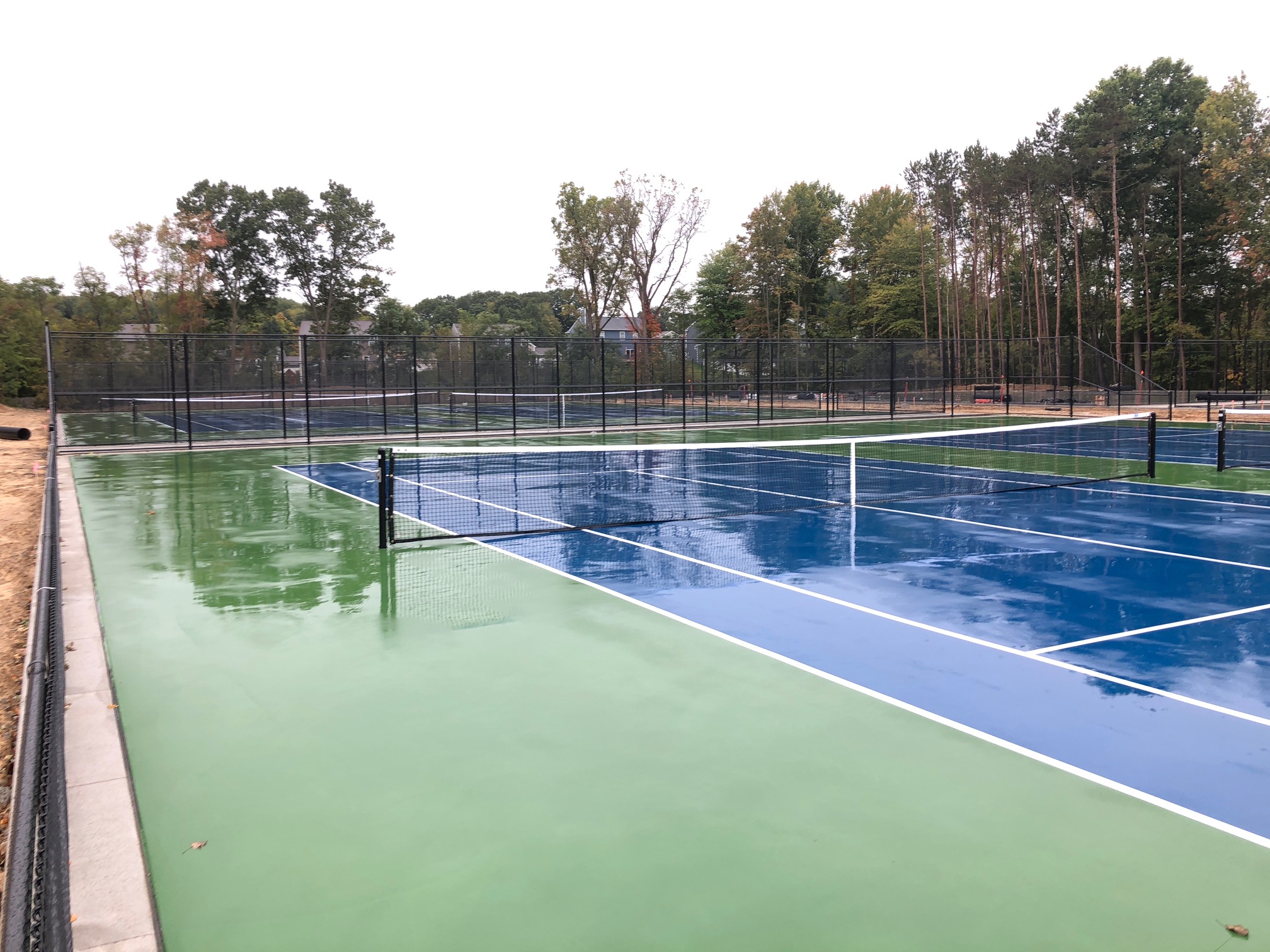 new tennis courts with paint and nets