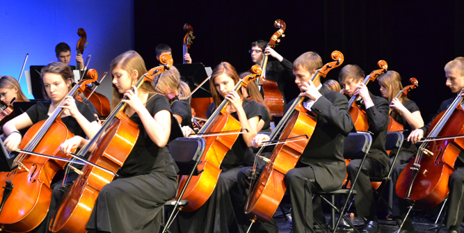 photo of orchestra students performing on stage.